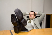 Overconfident negotiator leaning back in chair with feet on table - Peter barron stark companies